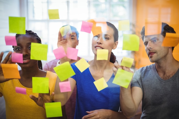 Business executives sticking sticky notes