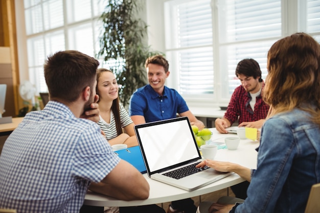 Business executives using laptop