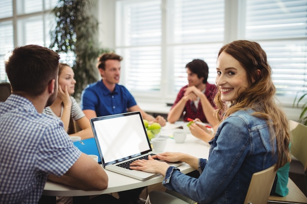 Business executives using laptop