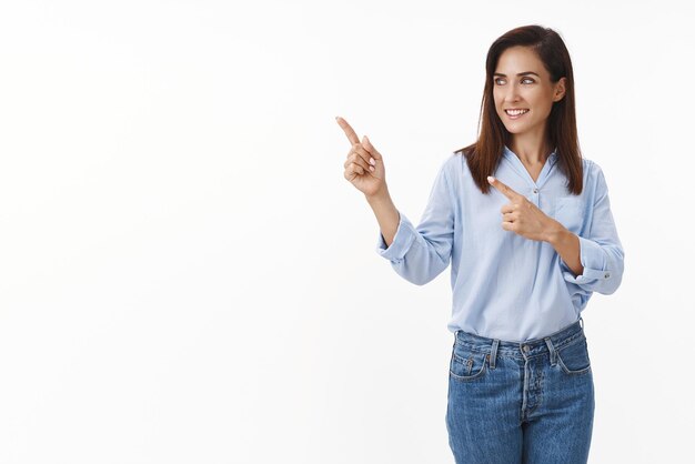 Business feminism confidence concept Motivated goodlooking stylish female entrepreneur introduce chart pointing sideways left copyspace turn aside smiling pleased show promo white background