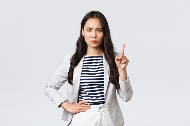 Business, finance and employment, female successful entrepreneurs concept. Angry serious-looking businesswoman teaching employee lesson, shaking finger in prohibition, scolding person