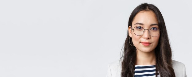 Business finance and employment female successful entrepreneurs concept Closeup of modern stylish asian businesswoman in glasses looking confident and determined at camera