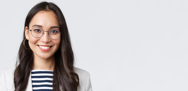 Business finance and employment female successful entrepreneurs concept Closeup of smiling asian beautiful businesswoman wearing glasses and suit looking confident and happy