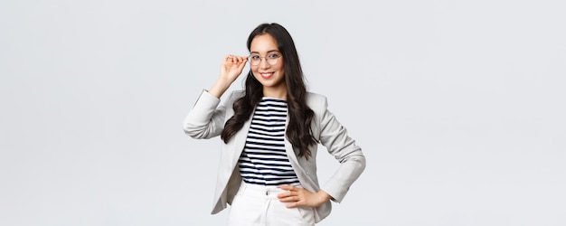 Business finance and employment female successful entrepreneurs concept Confident businesswoman in glasses and white suit ready for meeting smiling pleased standing determined