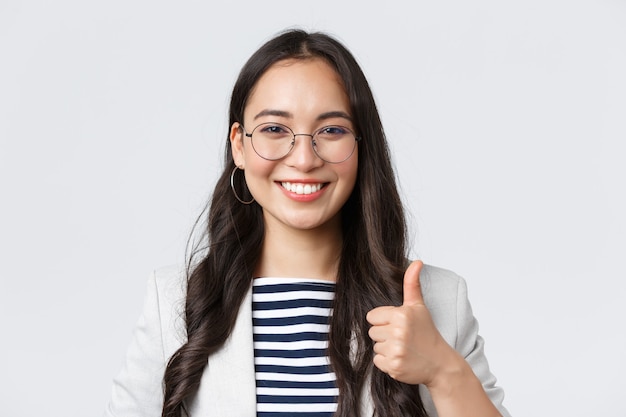 Business, finance and employment, female successful entrepreneurs concept. Confident smiling businesswoman provide best service, assure its good deal, thumbs-up in approval