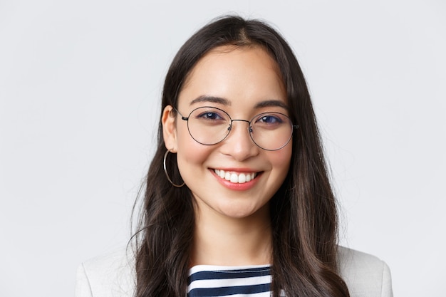 Business, finance and employment, female successful entrepreneurs concept. good-looking asian businesswoman in glasses and suit smiling friendly and confident, working in office