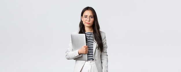 Business finance and employment female successful entrepreneurs concept Sad and doubtful businesswoman having hesitations about meeting smirk displeased holding laptop