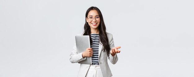 Business finance and employment female successful entrepreneurs concept Smiling professional businesswoman real estate broker showing clients good deal carry laptop in hand