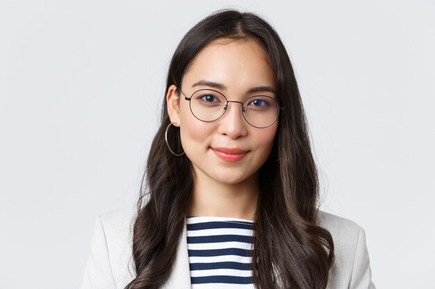 Business, finance and employment, female successful entrepreneurs concept. Smiling professional female office manager, CEO of e-commerce company looking pleased camera, white background