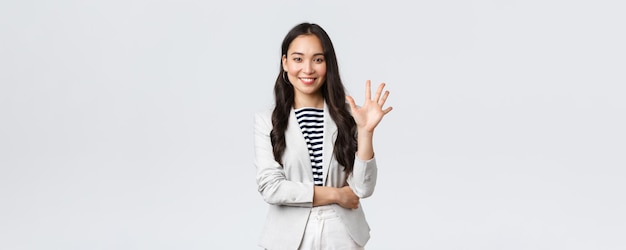 Business finance and employment female successful entrepreneurs concept Successful female businesswoman asian real estate broker pointing finger showing number five and smiling