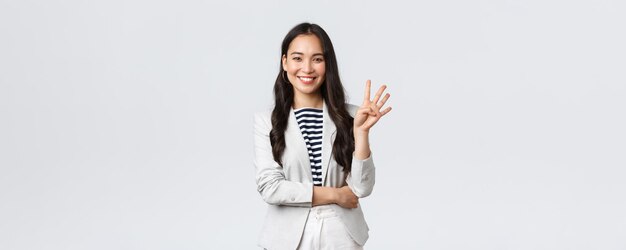 Business finance and employment female successful entrepreneurs concept Successful female businesswoman asian real estate broker pointing finger showing number four and smiling