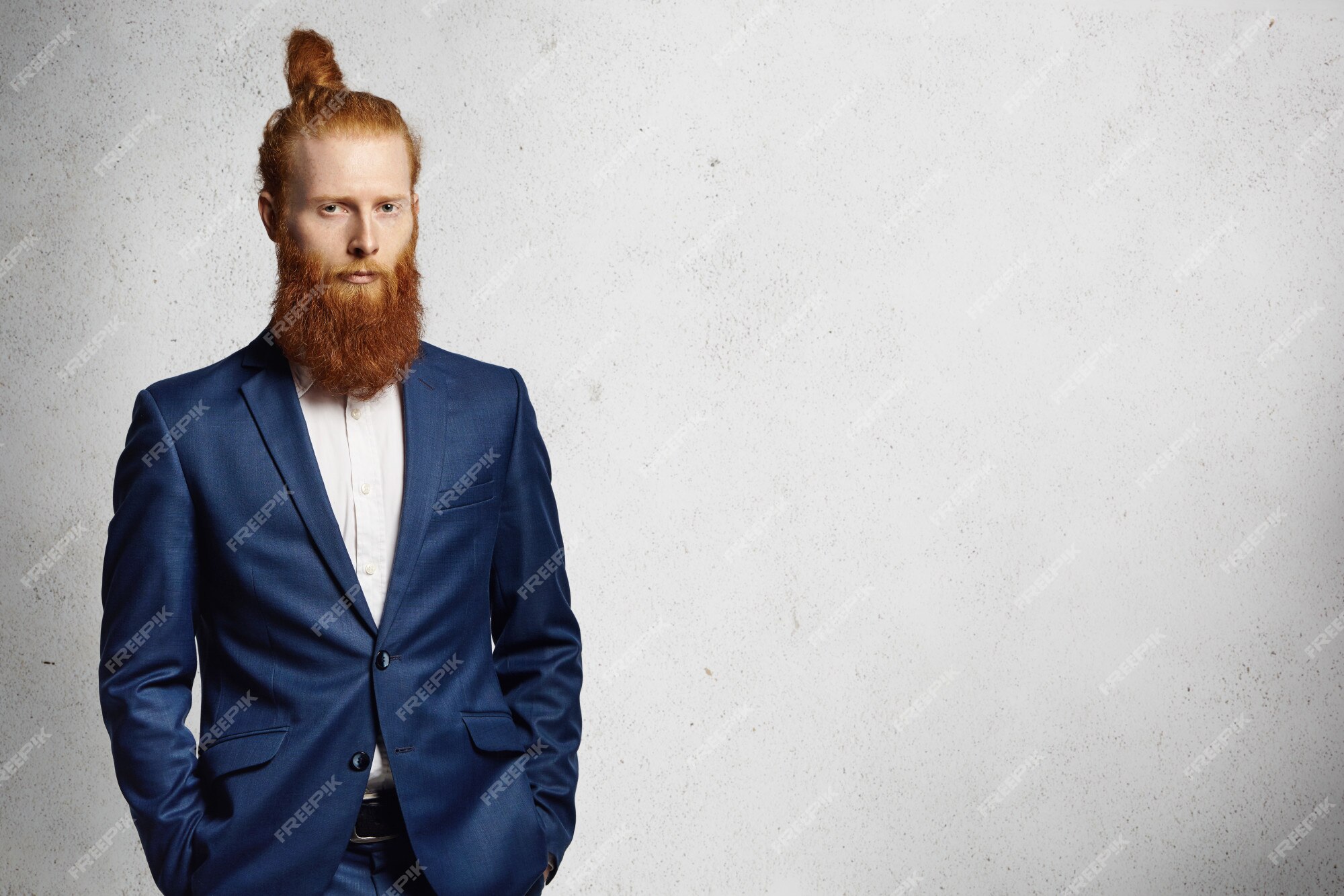 Free Photo | Business, formal style and fashion. good-looking redhead bearded entrepreneur with stylish hair bun dressed in blue elegant suit posing indoors, holding his hands in pockets. Free Photo | Business, formal style and fashion. good-looking redhead bearded entrepreneur with stylish hair bun dressed in blue elegant suit posing indoors, holding his hands in pockets.