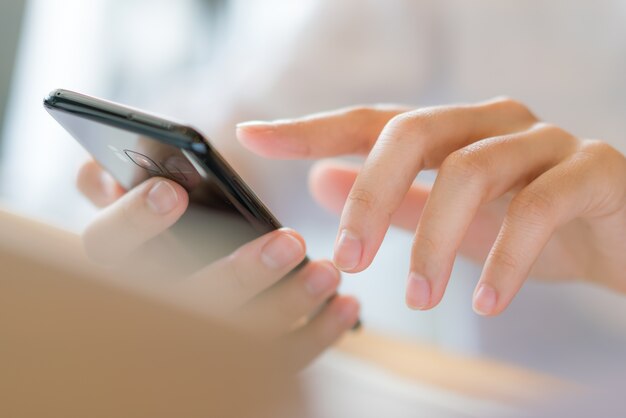 Business hand with mobile phone .