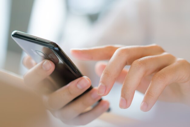 Business hand with mobile phone .