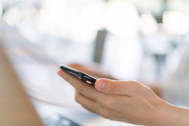 Business hand with mobile phone .