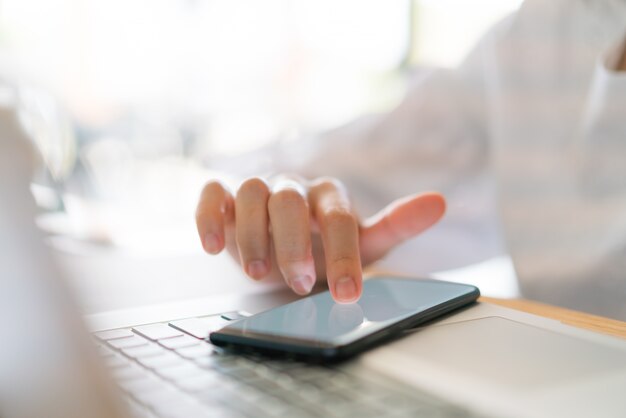 Business hand with mobile phone .