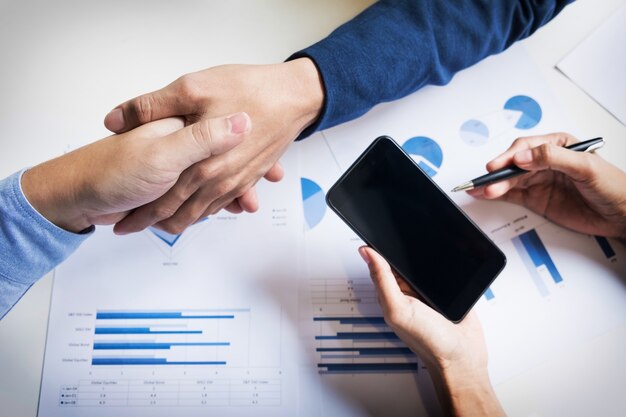 Business handshake of two men demonstrating their agreement to sign agreement or contract between their firms, companies, enterprises