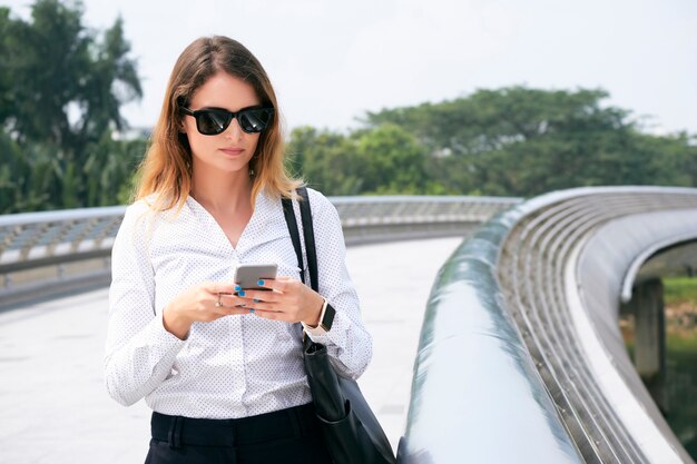 Business lady texting colleagues