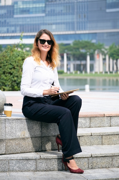 Business lady working in park