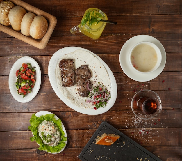 Business lunch with soup salad and meat kebab