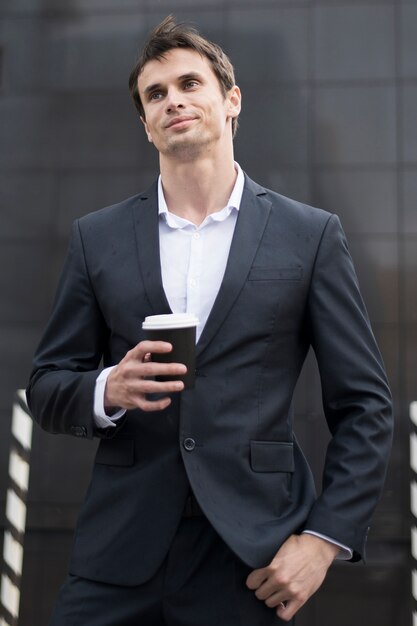 Business man on break with cup of coffee