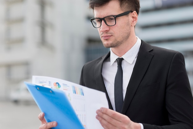 Business man checking clipboard