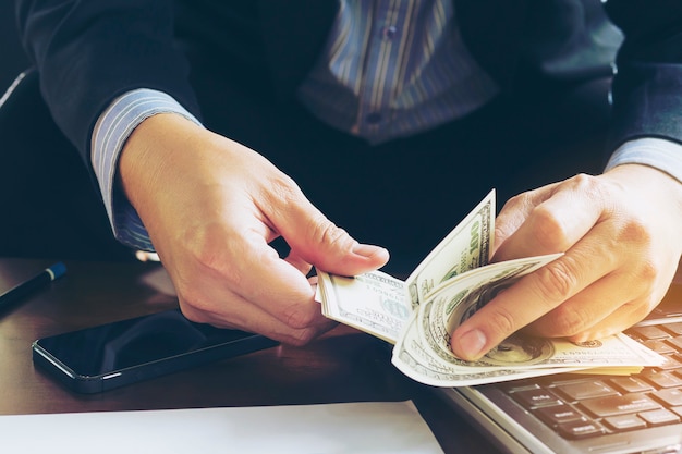 Free photo business man counting dollar banknote - online business concept