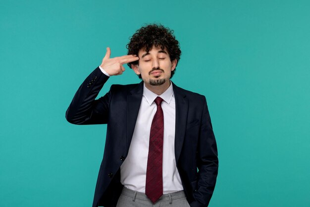 Business man curly cute handsome guy in black suit making gun to head sign gesture