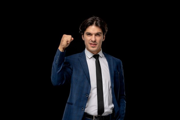 Business man cute charismatic man in dark blue outfit with the tie showing fist