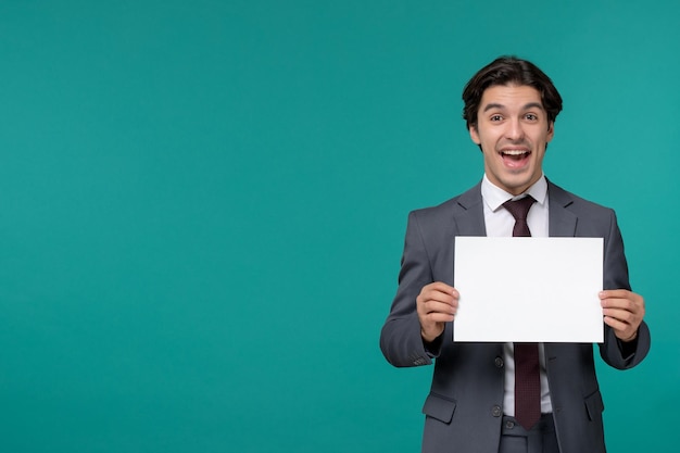 Free photo business man cute handsome guy in grey office suit and tie excited with paper sheet