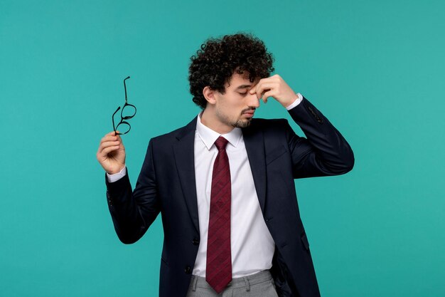 Business man cute pretty guy in black office outfit tired covering eyes and taking off glasses