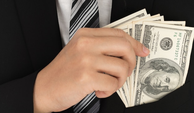 Free photo business man displaying a spread of dollar