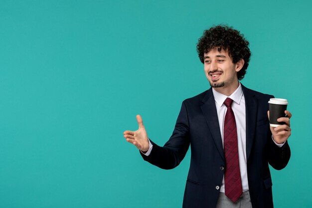 Business man handsome cute young guy in black suit and red tie giving handshake and holding coffee