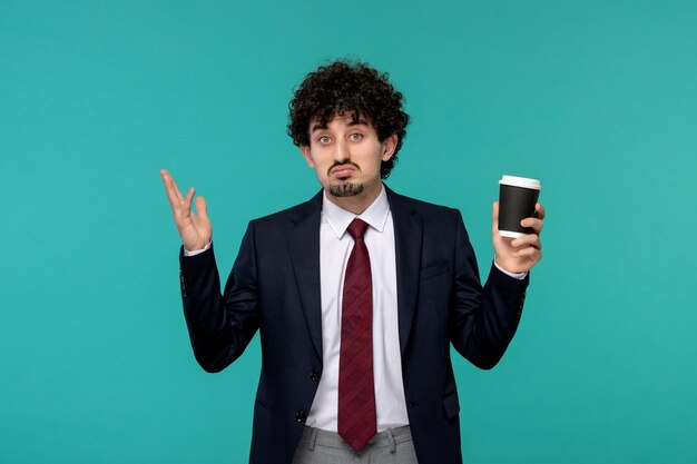 Business man handsome cute young guy in black suit and red tie waving hands confusingly