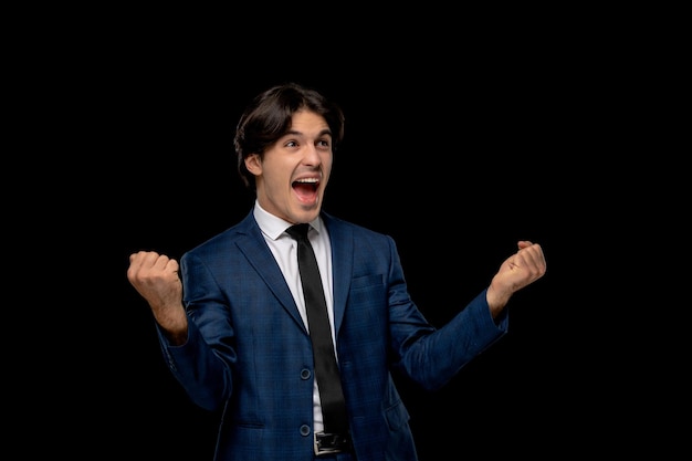 Business man handsome excited man in dark blue outfit with the tie holding fists