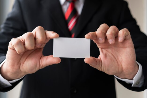 Business man holding blank business card