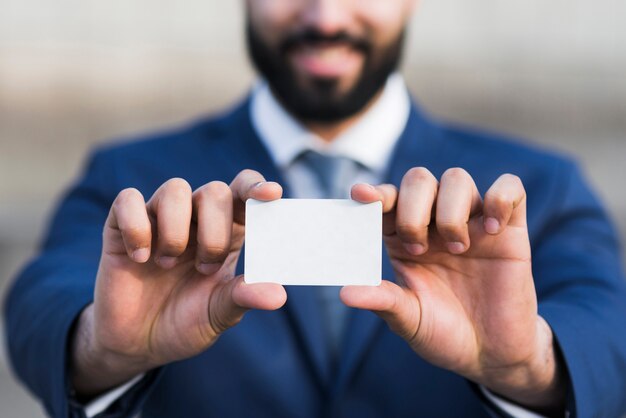 Business man holding business card