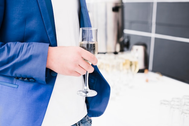 Business man holding cup of champagne