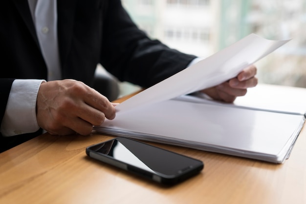 Business man holding glossy paper