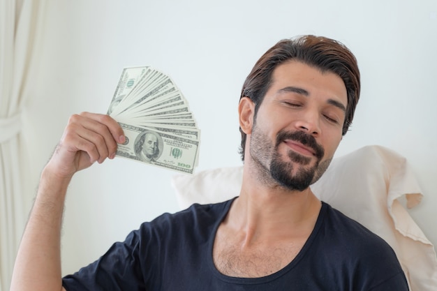 business man  holding money US dollar bills  in home office 