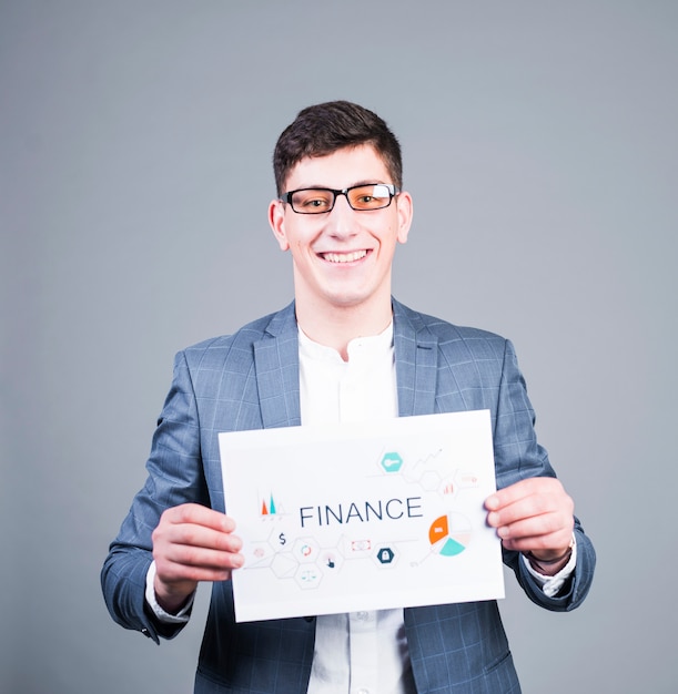 Business man holding paper with Finance inscription and smiling 