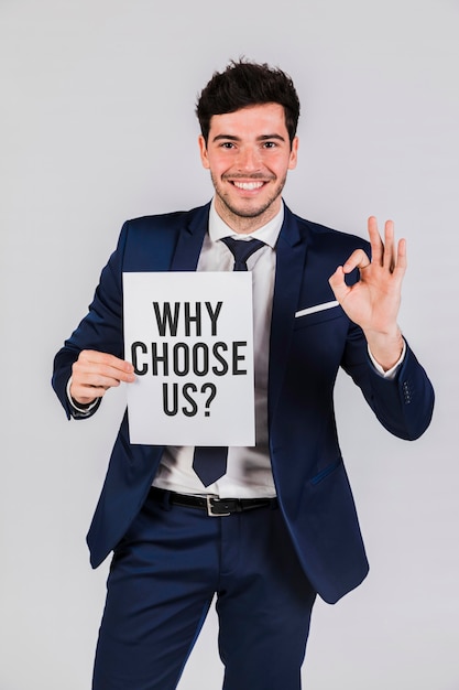 Free photo business man holding a paper with the why choose us question