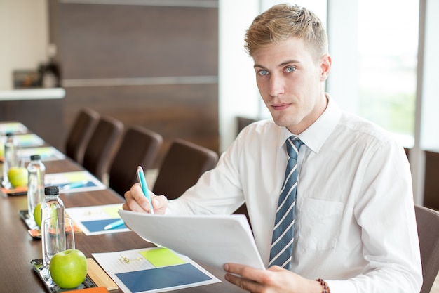 Free photo business man preparing speech at conference table