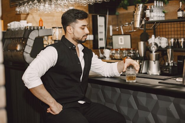 Business man in a pub, drinking alcohol