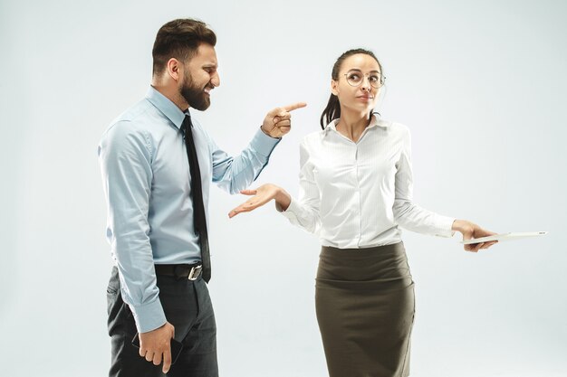 A business man shows the laptop to his colleague in the office