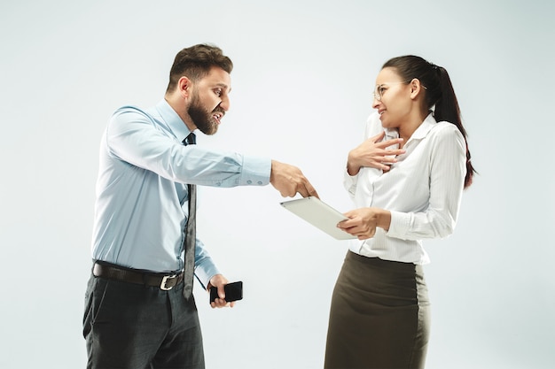 A business man shows the laptop to his colleague in the office.