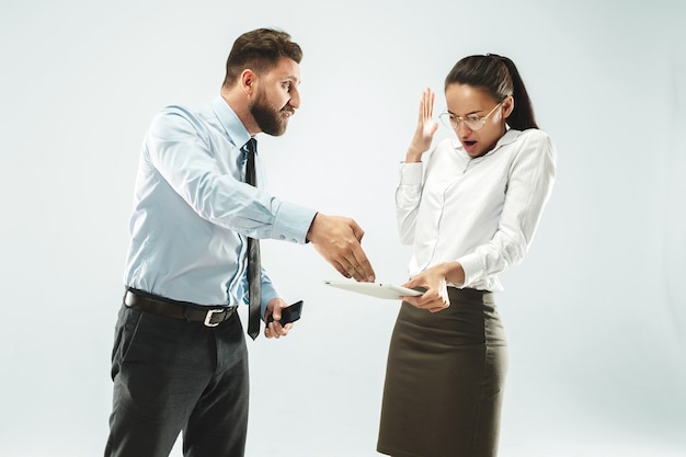 A business man shows the laptop to his colleague in the office.