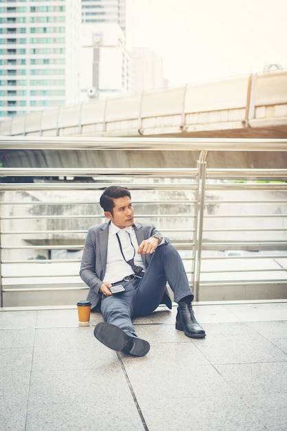 Business man sitting on the floor stressed.