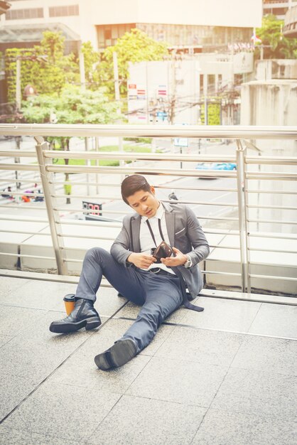 Business man sitting on the floor stressed.