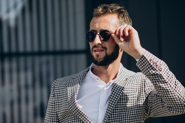 Business man standing outside the street